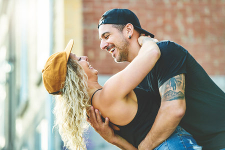 Beautiful couple having fun outdoors on urban backgroundの写真素材