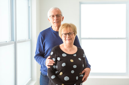 Cheerful dreamy older 60s married couple hugging with loveの写真素材