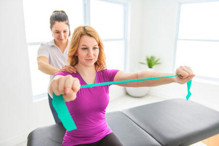 Modern rehabilitation physiotherapy at work with clientの写真素材