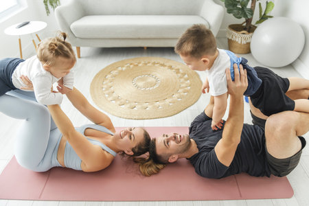 Portrait of happy healthy fit young family with little children standing togetherの写真素材