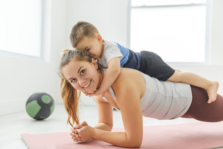 Sport Activities With Baby. Young Mom Exercising With Her Infant Son At Home