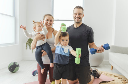 Portrait of happy healthy fit young family with little children standing together