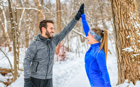 active runner couple jogging together in forestの写真素材