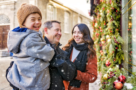 family with little son having fun together outdoor on frosty day