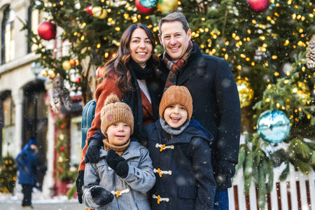family with two little son having fun together outdoor on frosty dayの写真素材