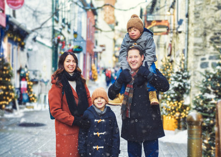 family with two little son having fun together outdoor on frosty day