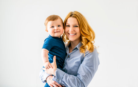 young beautiful mother with a baby boy on studioの写真素材