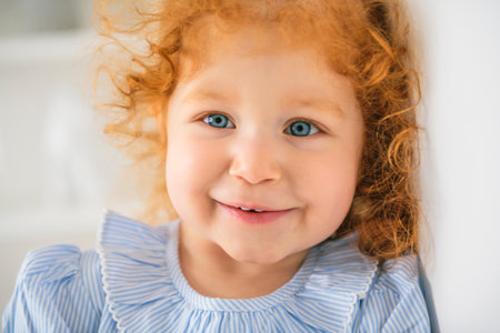 Little cute girl in a dress with redhead. The child is 2 years old.の写真素材