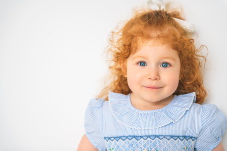 Little cute girl in a dress with redhead. The child is 2 years old.の写真素材