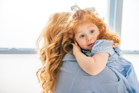 young beautiful mother with is daughter on studioの写真素材