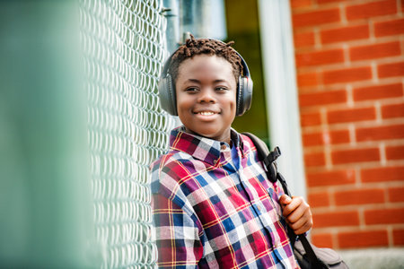Portrait Of Male Teenage Student Outside Buildings with headphoneの写真素材