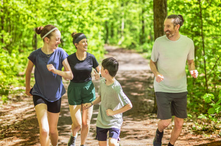 A Family exercising and jogging together at an outdoor park having great fun