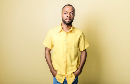 black African Man with yellow clothes on studio white backgroundの写真素材