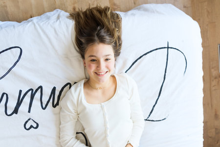 Teen spending time relaxing on bedroom at homeの写真素材