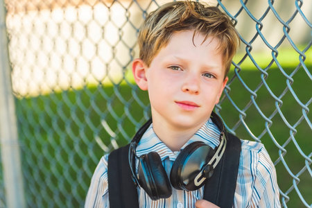 Elementary school boy outside carrying a backpack