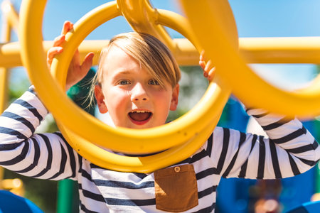 Child playing on outdoor playground. Kids play on school or kindergarten yard