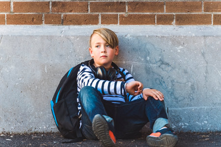 Elementary school boy outside carrying a backpack