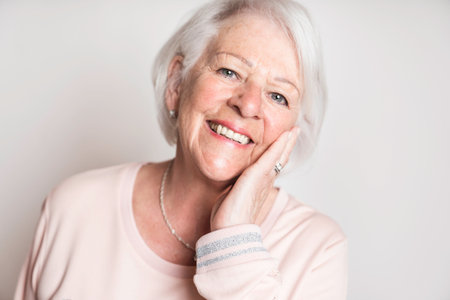 nice portrait of a retired senior woman on studio background