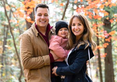 family having fun in the autumn forest