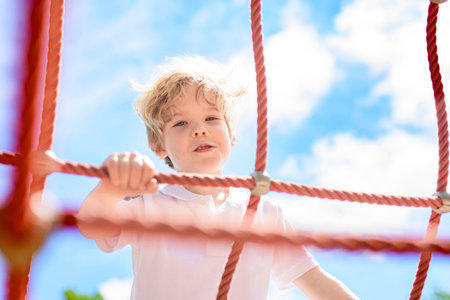 Active little boy having fun on playgroundの写真素材