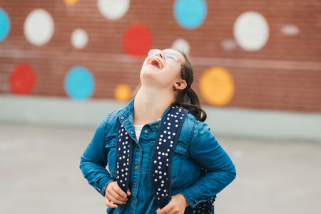 portrait of a child girl outside on a school playgroundの写真素材