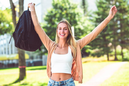 teen blonde school girl, college or university student with backpack