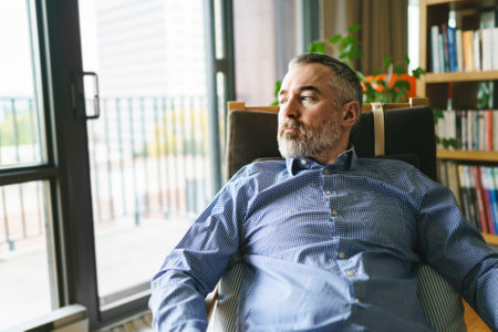 nice Joyful mature man at home appartement with grey beardの写真素材