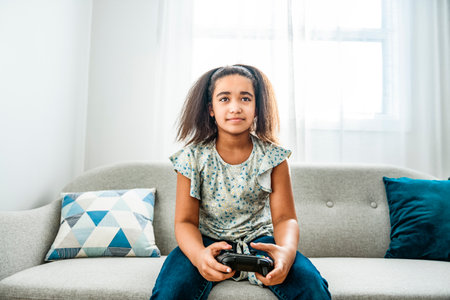 Young black woman using game controller to play video game