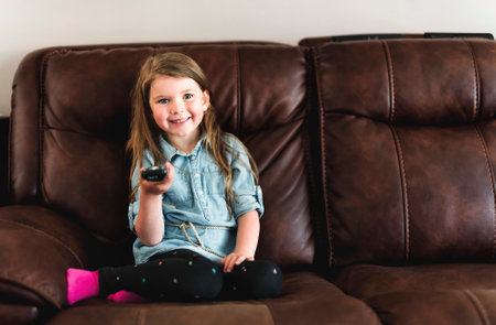 child watching tv laying at home aloneの写真素材