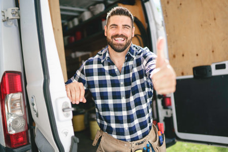 Portrait of an electrician happy worker at work
