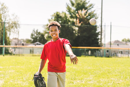 portrait of child with glove and looking at camera playing baseball