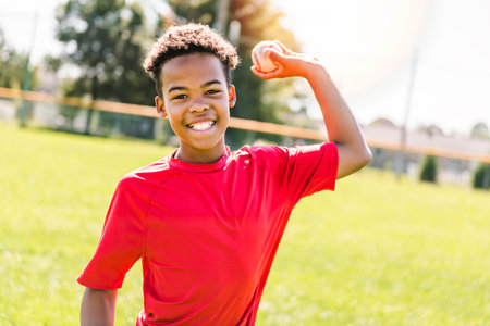 portrait of child with glove and looking at camera playing baseball