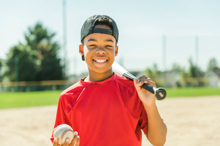 portrait of child with glove and looking at camera playing baseball