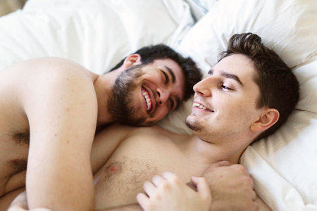 homosexual couple on a bed at homeの写真素材