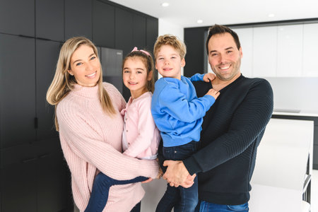 Family of four having fun on new modern house