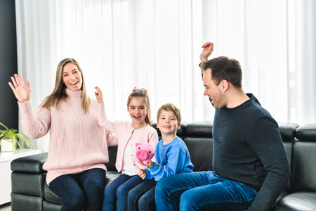 Family of four having fun on new modern houseの写真素材