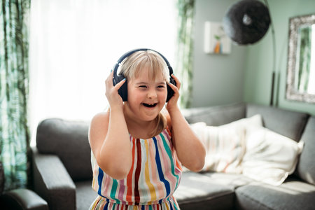 child girl having great time on the living room at home listening music