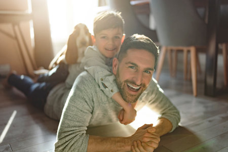 Father or Godfather having fun on the apartment floor At Home