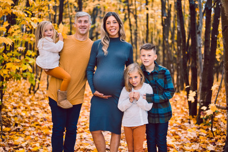 pregnant mother and family on autumn nature outdoors