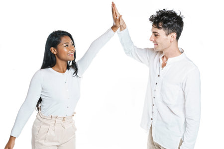 young couple standing together posing in studio white background hit the hand