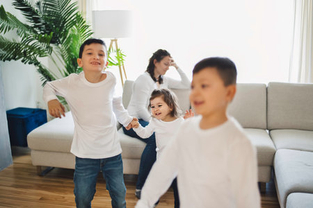 living room desperate mother with kid around look like crazyの写真素材