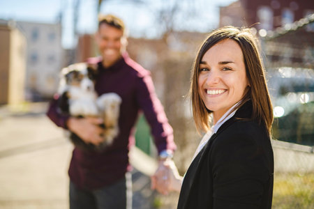 Handsome couple with her Australian Berger puppy city street outside