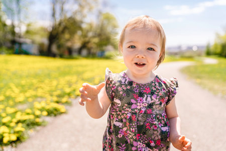 nice and Cute baby girl walking outdoorsの写真素材