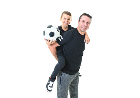 Young man and a boy with a soccer ball isolated on white background