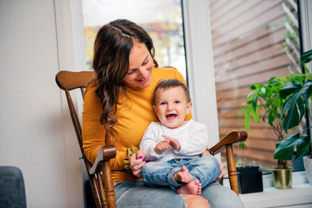 mother and baby girl having great time on the living room