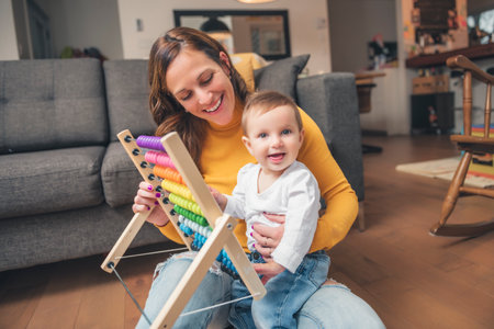 Adorable Infant Baby Playing At Home Living Room play whth her motherの写真素材