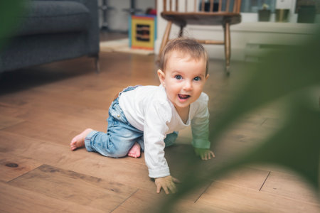 baby 9 months old learns to crawl at home. baby crawling on the floor