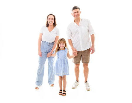 Parents and daughter having fun on studio portrait. Full body shot