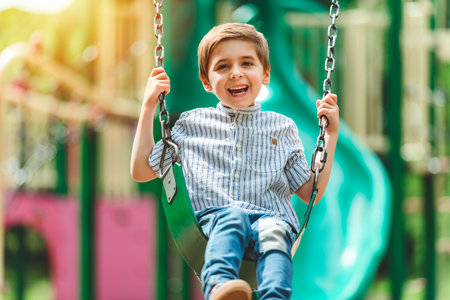 Baby boy having fun on a swing.の写真素材