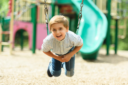 Baby boy having fun on a swing.の写真素材